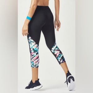Fabletics capri leggings in black with geometric print design.